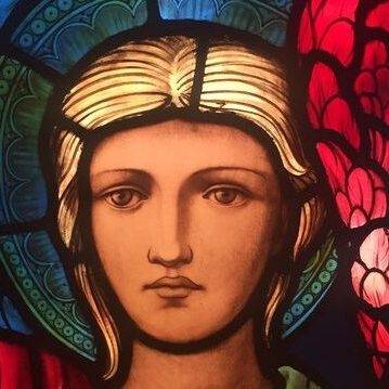 A close up of the face of an Angel from The Ascension window.