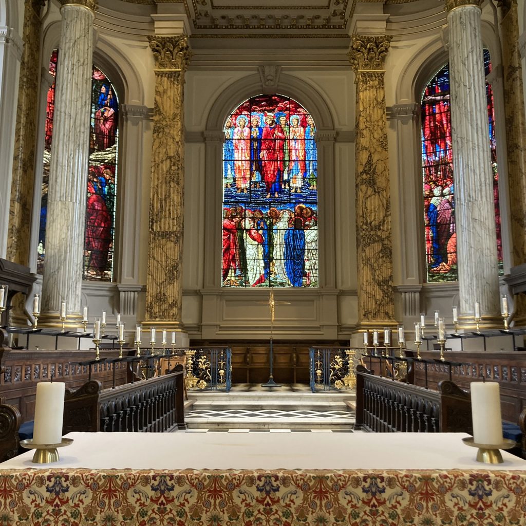 A view across the Alter and choir stalls, with The Ascension window in the background.