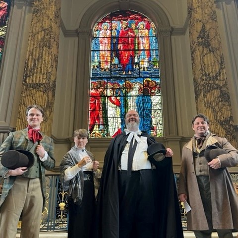 Actors performing a re-enactment of the commissioning of the stained-glass windows.