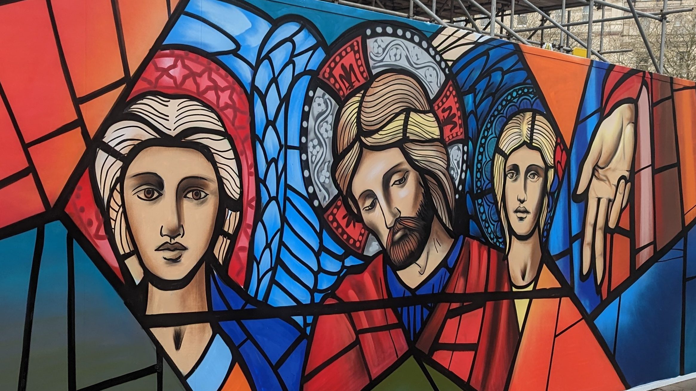A piece of graffiti street art depicting images from The Ascension window by Edward Burne-Jones and William Morris.  In the centre of the image is Jesus, with an angel on either side.
